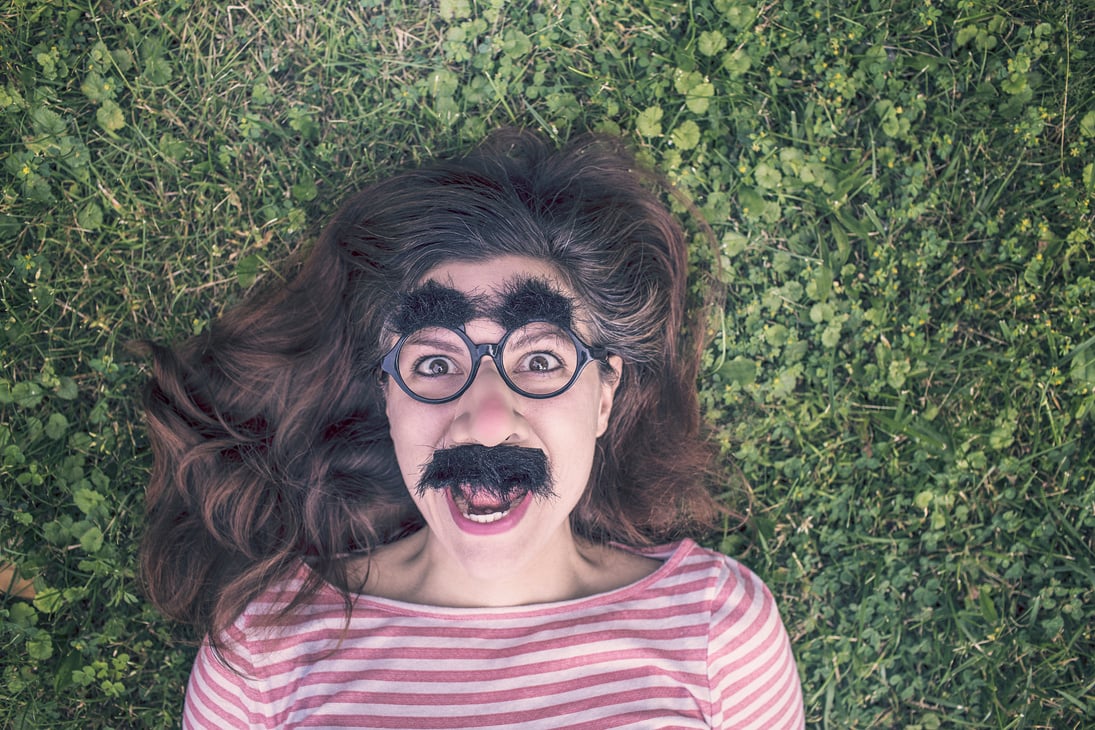 Woman in Red and White Striped Top Lying on Green Grass